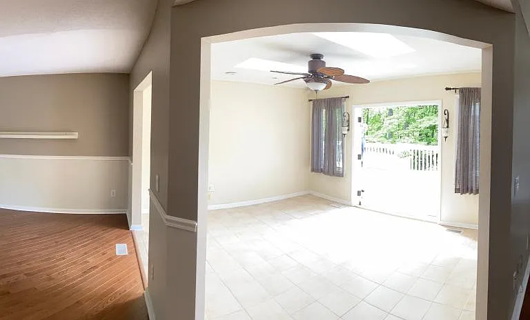 Panoramic from kitchen looking into dining area, sunroom, living room