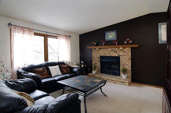 Spacious, vaulted living room with wood burning fireplace.