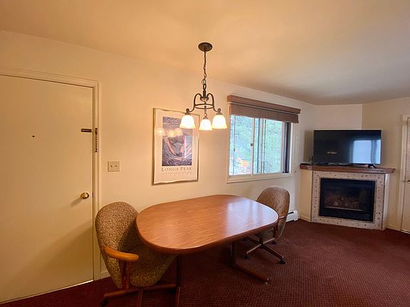 Entry door into the living room/kitchen and table for 2-4 people.