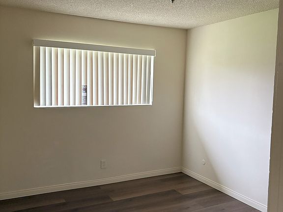 Bedroom with spacious closet and new flooring