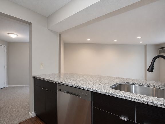 Kitchen includes microwave, dishwasher, granite breakfast bar