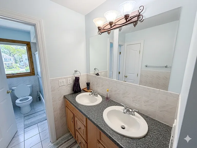 Bathroom with double vanity and shower / tub