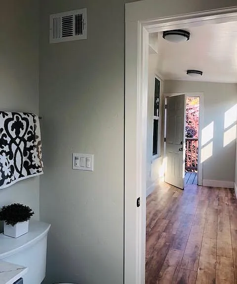 Bathroom opens to sunroom. Sunroom has exit to back staircase.