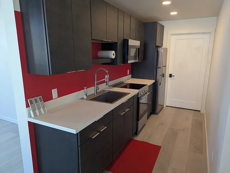 Compact kitchen with range, microwave and refrigerator