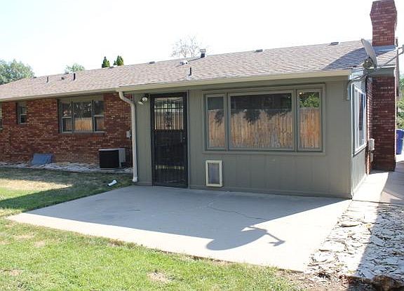 Back of Home with Dog Door in the Insulated Four Seasons Room to Privacy Fenced Back Yard