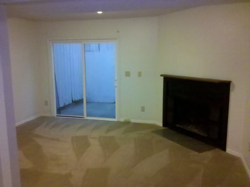 Living room with working fireplace. Patio and storage w/washer.