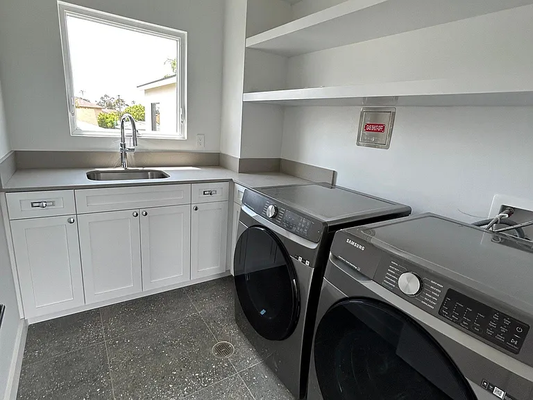 upstairs laundry room with new appliances