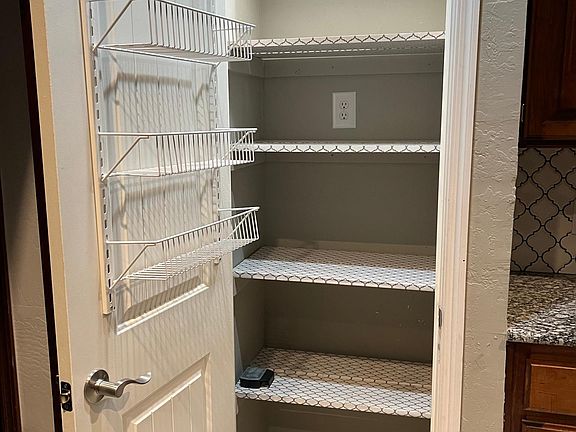 Lighted chef's pantry. Lots of space for pots, pans and cookbooks!