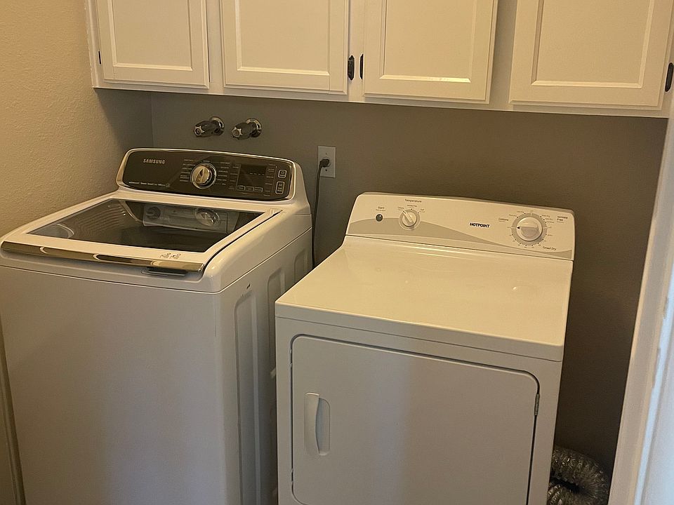In-unit laundry room next to pantry