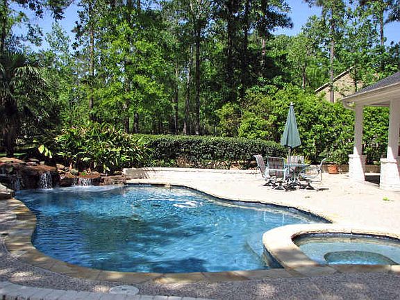 A backyard paradise awaits! The salt water pool with soothing rock waterfall and spa is surrounded b