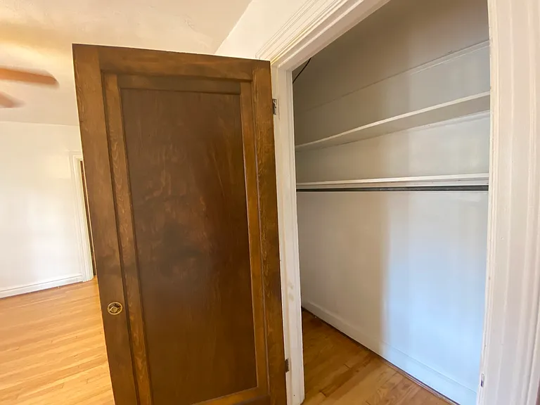 In total, there are three closets in this unit. All three make sure to maximize the vertical storage space with additional shelving.