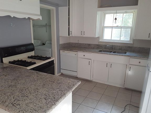 Kitchen with granite tops, stove, dishwasher