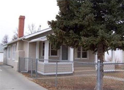 Front view of porch with large fir tree