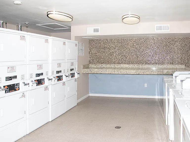 On-site laundry center with multiple machines and clean environment