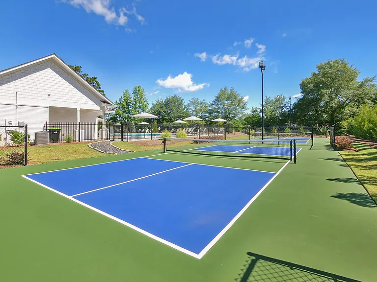 Tennis court conveniently located beside the clubhouse for easy access.