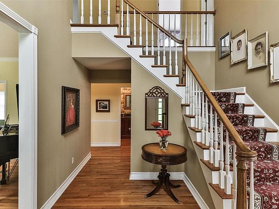 Gracious two story entry foyer flanked by living room and dining room
