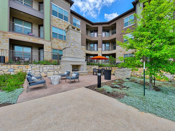 Poolside Stone Fireplace with Cozy Seating and Grilling Area