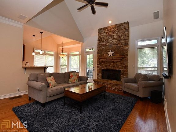 One of the living areas.  This one opens to the kitchen and breakfast area.  Warm gas fireplace, and a door the the spacious deck and back yard.