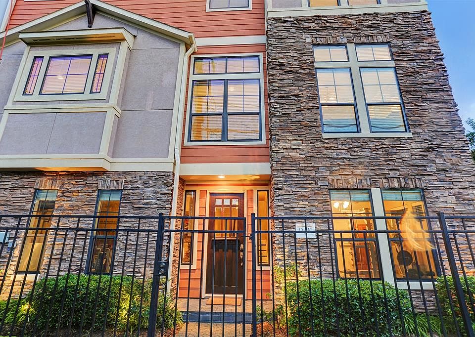 Front of townhome featuring stacked stone, stucco and hardiplank siding. Townhome is on the corner of the courtyard and receives lots of natural light.