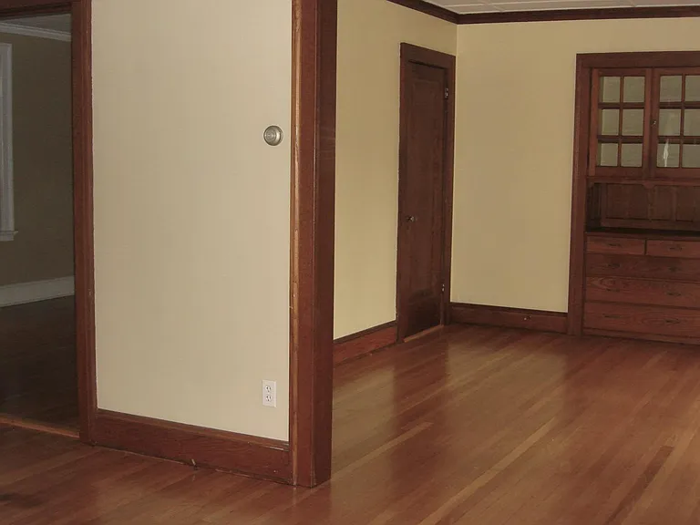 Living room to dining room. Natural woodwork with builtin china cabinet. To far left is door to Bedroom #1 from Living Room.