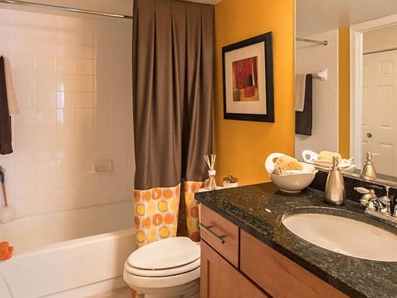 Spacious full-bath is upstairs with maple cabinets and granite countertops. There is an additional half bath downstairs.