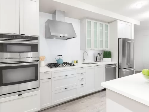 Kitchen with white cabinetry, quartz stone countertops, ceramic tile backsplash and stainless steel appliances - Avalon Dogpatch