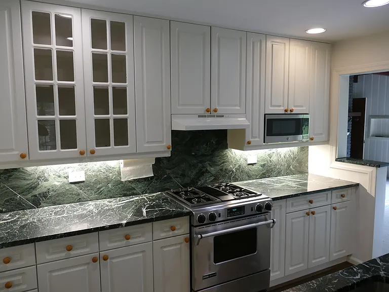 Green Marble countertops. Jenn Air stove has direct exhaust to outside.