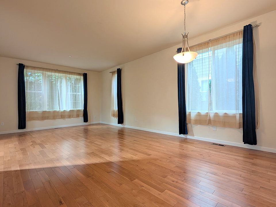 Large living room with dinning area under the light fixture