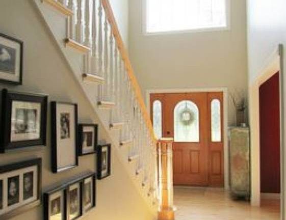 Sun filled 2 story foyer offers a warm welcome with maple hardwood floors and updated decor.