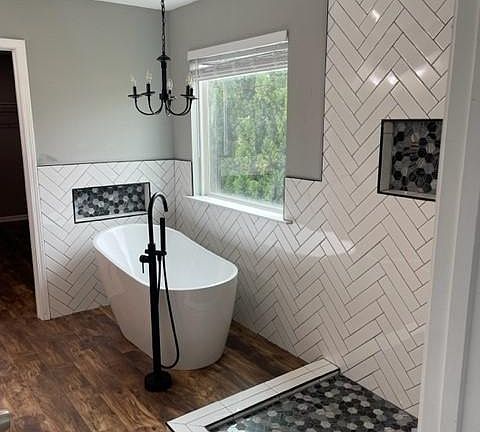 Soaking tub, separate glass enclosed shower in primary bathroom. Dual vanity sink, water closet, and walk-in closet.