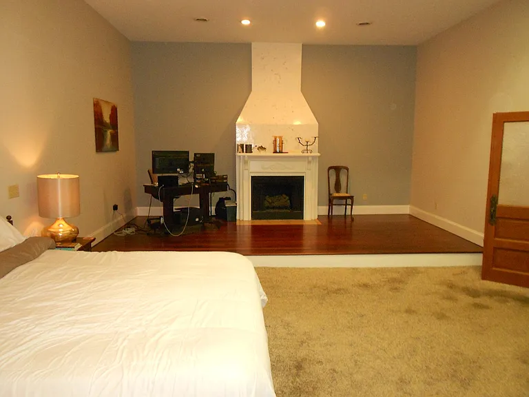 Master bedroom with reading area and fireplace