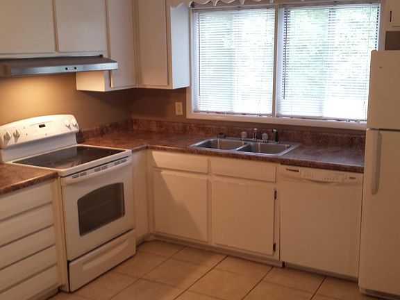 Kitchen - Tile flooring, electric stove, dishwasher and refrigerator