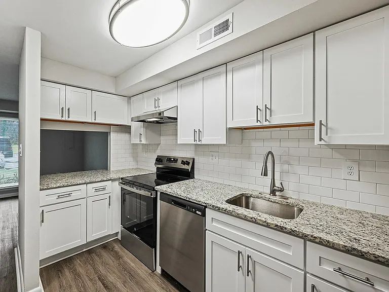 Experience cooking in a modern kitchen with stylish finishes and ample storage.