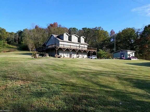 This absolutely gorgeous home features a wrap around the entire house porch!  Look at that yard!!