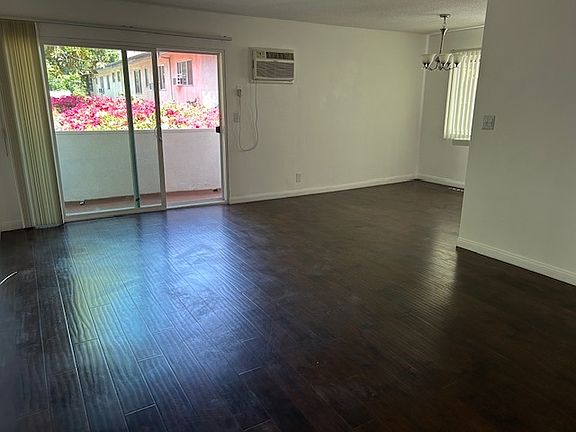 large living room with ac and eating area, balcony