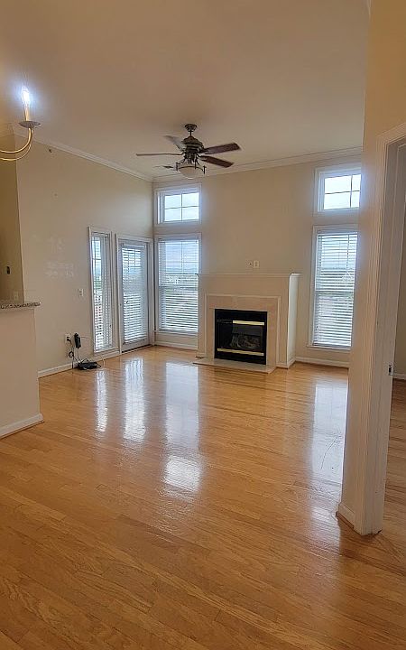 Living Room with Fireplace and two big windows. As you enter, the dining space is on the left side.