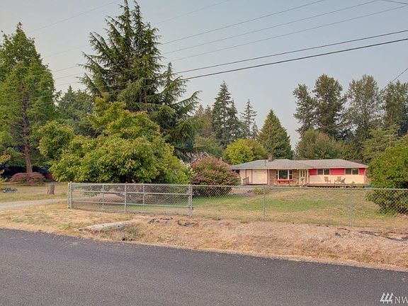 View of the home and the acreage from 66th Ave E. The home/acreage is located off 104th between Canyon and Woodlawn. Easy access to 512 and I-5. 