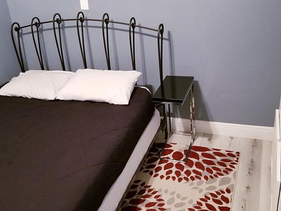 This bedroom easily accommodates a queen size bed. You will enjoy the high ceiling!