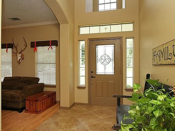 Vaulted entry with arched opening to dining room with lots of natural light.
