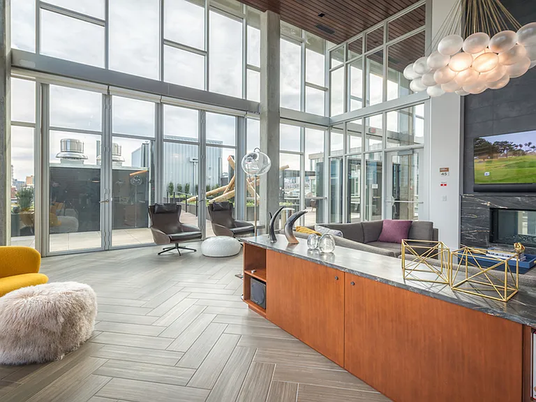 Resident lounge with ample seating options around a large wall mounted television