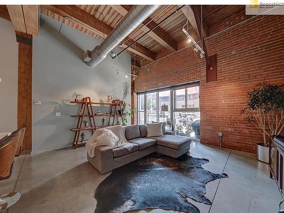 Living area. Beautiful exposed brick & large windows.