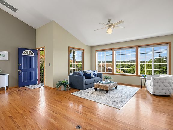 Sun-filled living room with expansive territory view. Perfect vantage for your morning coffee.
