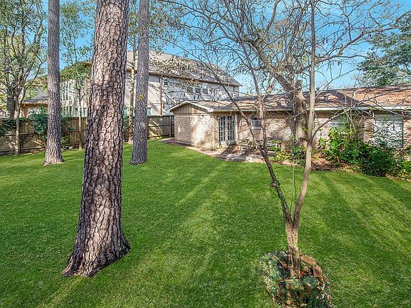 Large backyard lawn, patio and garden areas.