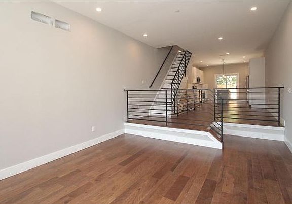 Large, extra wide living room allows for plenty of space for furniture and relaxing. This is the view from the front door.
