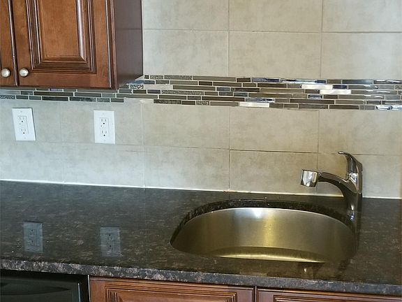 Granite Countertops, Solid Wood Cabinets, Stainless Steel Dishwasher, Custom Tiled Backsplash