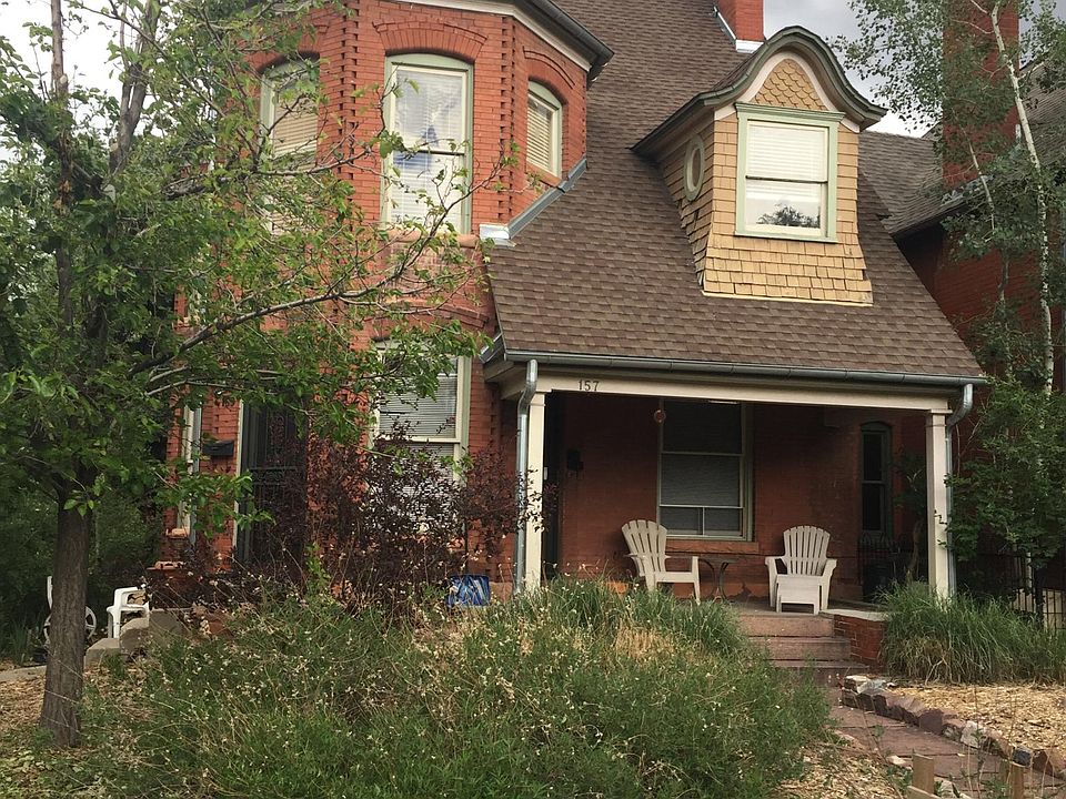 The house with the studio entrance in front with covered porch