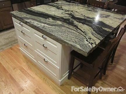 custom island with granite slab
						:
						six extra deep drawers and two large cabinets for appliances