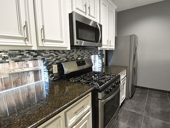 Granite countertops and updated backsplash, windows that allow light into the kitchen, updated appliances.