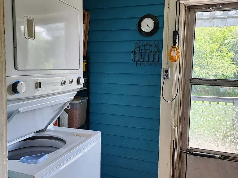 Laundry room with storage rack, ironing board, iron, cleaning supplies
