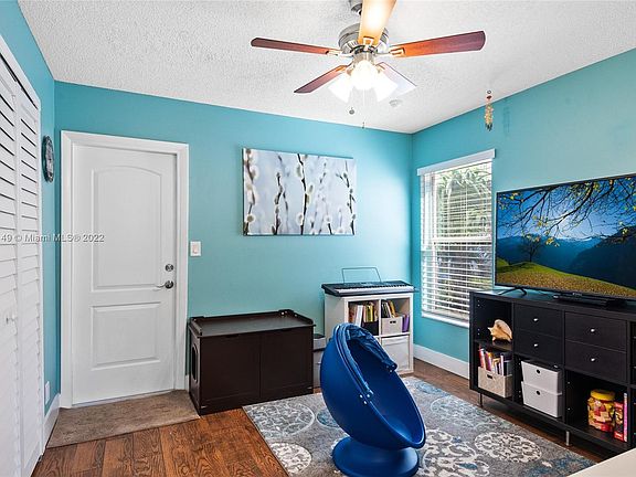 Family room with washer and dryer in the closet. Door to storage